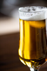 Beer glass details with fresh bubbles and foam. Iced beer details on glass