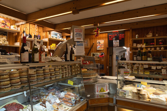 Jura, France - December 30, 2020: Food specialties shop interior. Local delicious sausages and ham, gourmet fois gras, wine, sweets and famous Comte and goat cheeses.