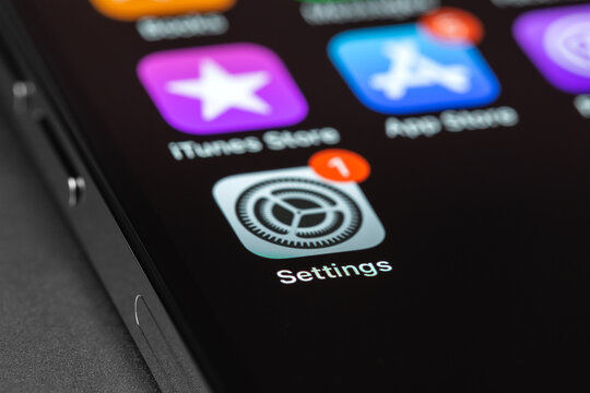 iPhone with Settings, iOS update on screen, interface icons closeup. Apple is a multinational technology company. Moscow, Russia -  September 5, 2021