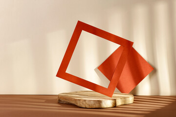 Natural board and frame with free space, shadows of light on the wall 