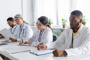 multiethnic physicians working with documents during medical conference
