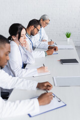 Fototapeta premium multiethnic doctors working with documents in hospital conference room