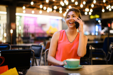 Portrait of a young woman talking on the phone on a break