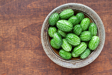 Cucamelon (Melothria scabra) in ceramic bowl. Own mouse melon organic fruits plant.