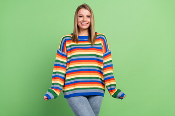 Photo portrait girl smiling wearing colorful striped sweater jeans isolated pastel green color background