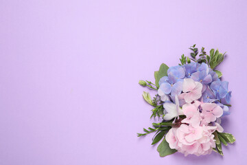 Beautiful hortensia flowers on violet background, flat lay. Space for text