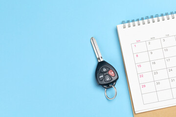 Car keys and calendar on a blue background. Template Copy space for text - obrazy, fototapety, plakaty
