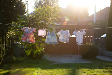 Baby clothes hanging on the rope outdoor.