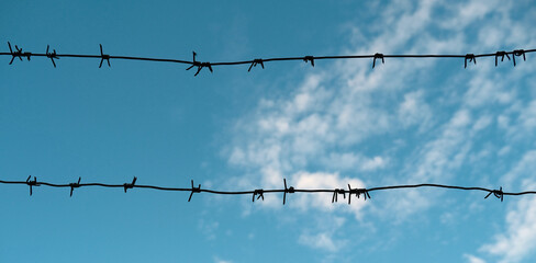 metal barbed wire on sky
