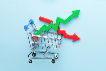 Shopping cart and green arrow up and red down. Stock market trading