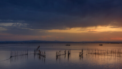 Albufera, Valencia lagoon in Spain. Close to sunset time with an impressive cloudy sky and beautiful colors.