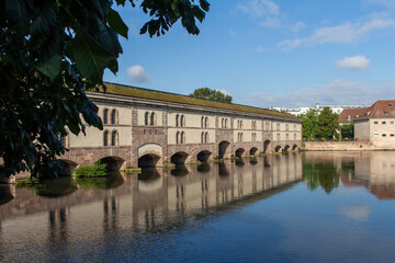 Beautiful view of the Barrage Vauban, a defensive city dam structure on the Ill River (also called...