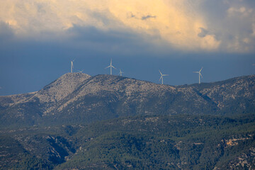 Mugla - Turkey Wind farm in Yılanlı mountain, Wind turbines at the top of the mountain, Green ecological energy production. Alternative power plant, cloudy sky .