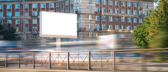 Horizontal billboard next to the road with blurred cars, mockup with advertising space.