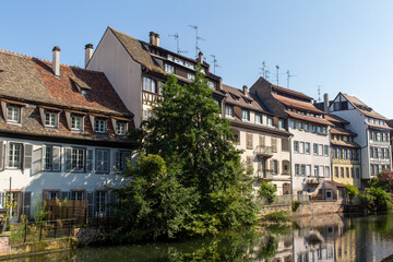 Fototapeta na wymiar Beautiful French and German style traditional half-timber framed homes along the tranquil River Ill in Strasbourg, France