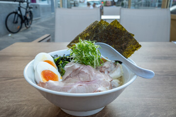 Shio Ramen, Japaneses noodle slat clams soup, on top with pork, boiled egg, bamboo shoots, Red...