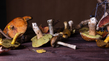 Forest mushrooms lie on a wooden table