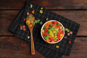 Mix of delicious candied fruits on wooden table, flat lay