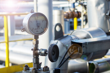 Industrial pressure gauge on the background of a chemical plant. Pressure gauge readings.