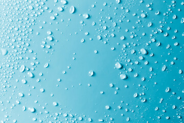 Water drops on smooth surface, blue background - 456786440