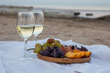 picnic by the sea. wine in glasses. figs, jamon, peach and other snacks.
pleasant evening picnic....