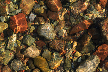 Background with transparent sea water with stones