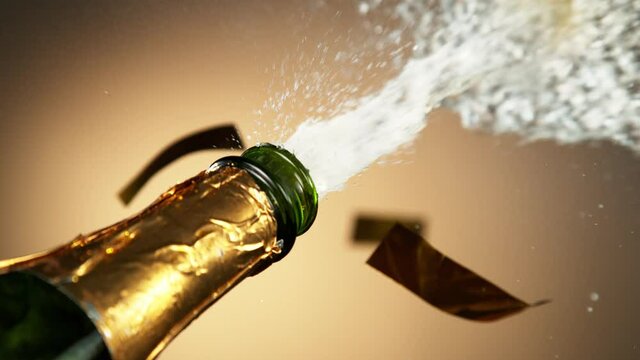 Super slow motion of Champagne explosion with falling confetti. Filmed on high speed cinema camera, 1000fps