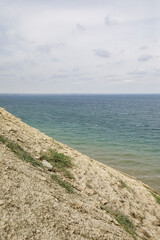 Fototapeta na wymiar Hilly coast and blue expanse of the Black Sea. Cloudy weather at sea.