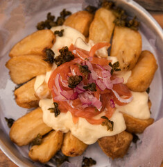 Fries. Top view of roasted potatoes with mozzarella cheese and smoked salmon. 