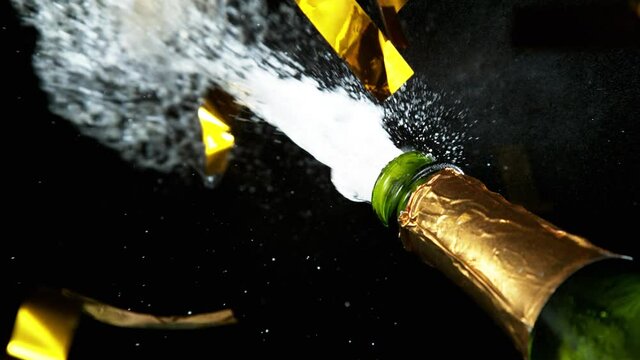 Super slow motion of Champagne explosion with falling confetti. Filmed on high speed cinema camera, 1000fps