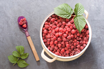 a full pan of ripe raspberries and a spoon for jam, a large harvest of healthy berries, a healthy diet. Favorite delicacy, preservation of Natural vitamins for the winter