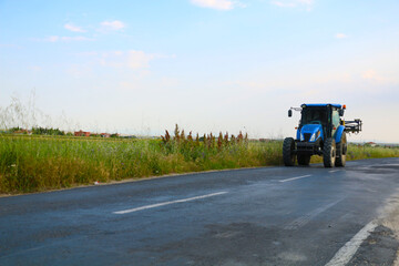 Fototapeta na wymiar selective focus, big blue tractor used by farmers in fields