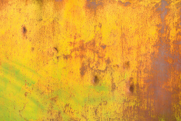 Texture of metal of old with peeling yellow green paint and rust