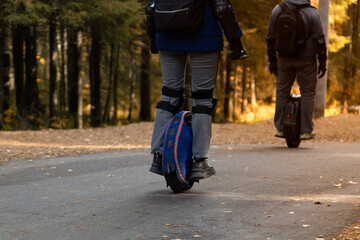 Monowheel.People ride a monowheel in the autumn park. © Александр Поташев