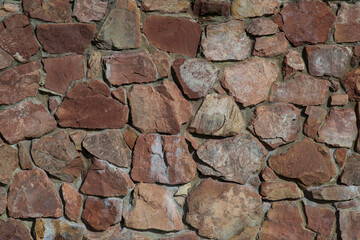 The background of the wall is made of natural stone.