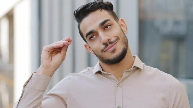 Funny humorous male portrait outdoors hispanic bored business man disappointed guy showing bla-bla-bla hands gesture and rolling eyes isolated in city outdoors. Empty promises blah liar gesticulation