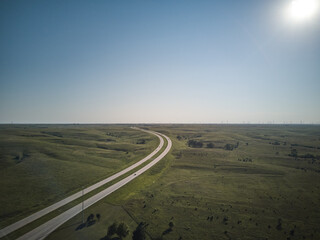 Aerial drone image of Highway 70 west and east bound through the state of Kansas in late afternoon light