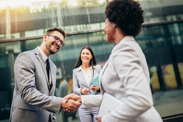 Businessman shaking hand to partner outdoor.