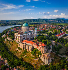 Fototapeta na wymiar Esztergom, Hungary - Aerial view of the Primatial Basilica of the Blessed Virgin Mary Assumed Into Heaven (Basilica of Esztergom) on a summer day with blue clouds and River Danube at background