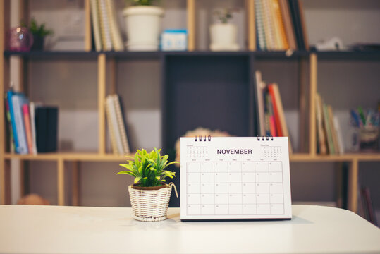 Calendar desk place on table. Desktop Calender for Planner to plan agenda, timetable, appointment, organization, management each date, month, and year on wooden office table.Calendar Concept.