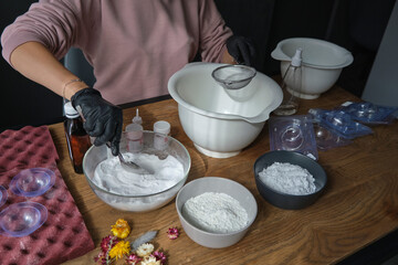 handmade bath bombs process. Preparation of bath bombs. Ingredients and floral decor on a wooden vintage table.