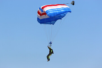 Skydiver in a blue sky	