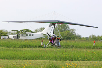 Fototapeta na wymiar Ultralight airplanes on a grass airfield 