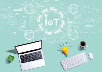 IoT theme with computers with a light bulb from above