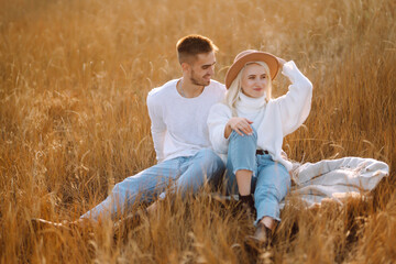 Young couple having fun walking and hugging  during autumn sunny day. Enjoying time together. The concept of youth, love and lifestyle.