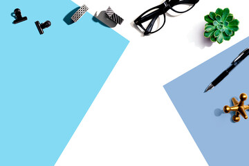 Office supplies and a plant - flat lay