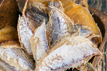 dried and butchered small fish on a wooden table