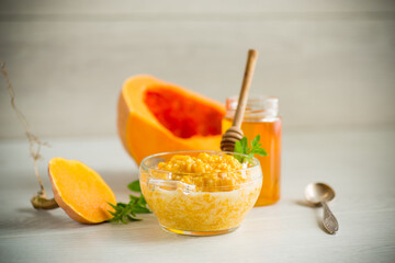 sweet boiled pumpkin porridge in a bowl with honey