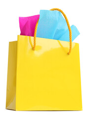 Yellow gift bag stuffed with pink and turquoise tissue paper, isolated on white