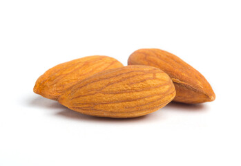 Three almonds close-up photo on white. Macro food shot
